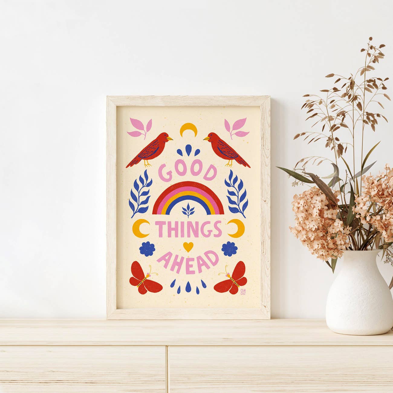 Affiche murale colorée avec des animaux, des fleurs, un arc en ciel, et un message positif, dans un cadre en bois.